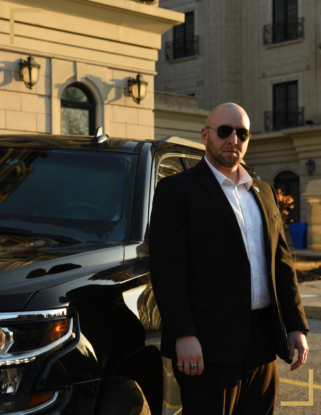 Protection professional standing beside a black SUV