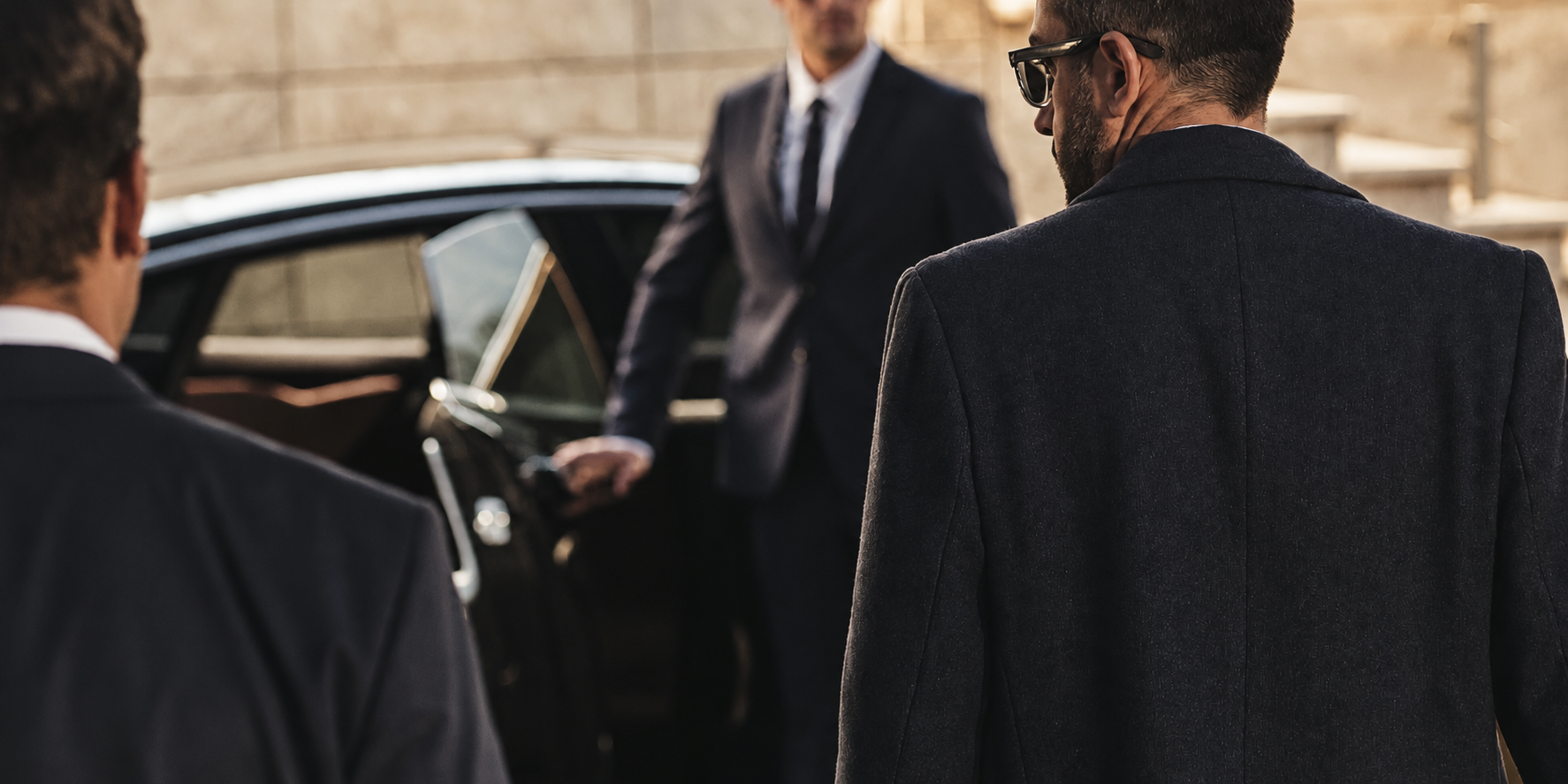 Personal protection team beside an open vehicle door