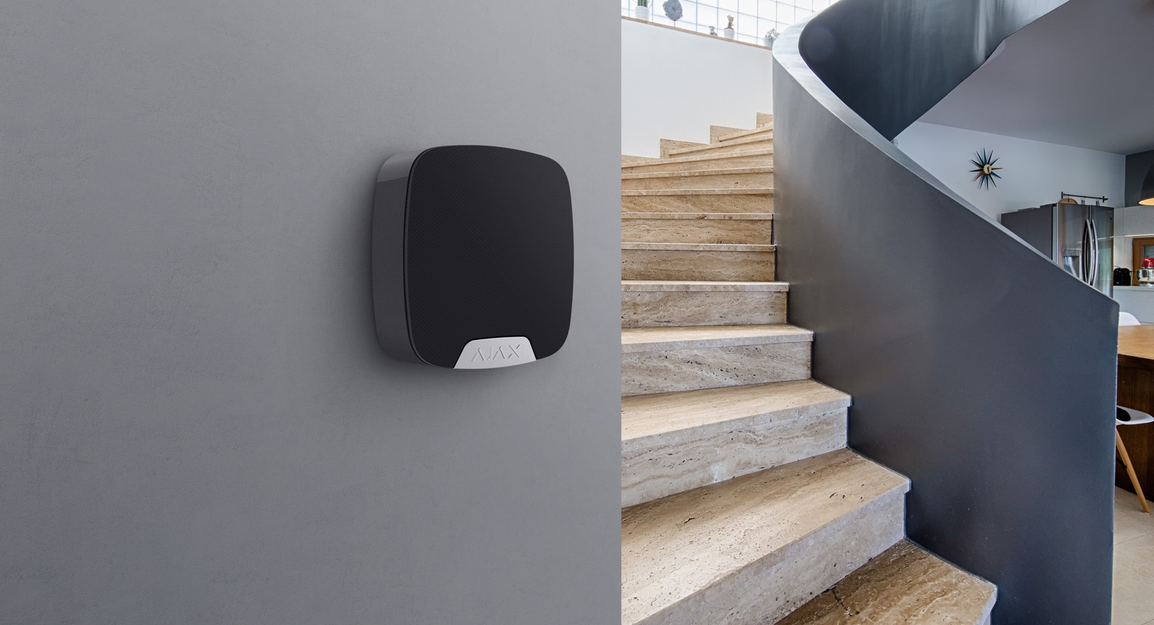 Home alarm beside a curved stone staircase