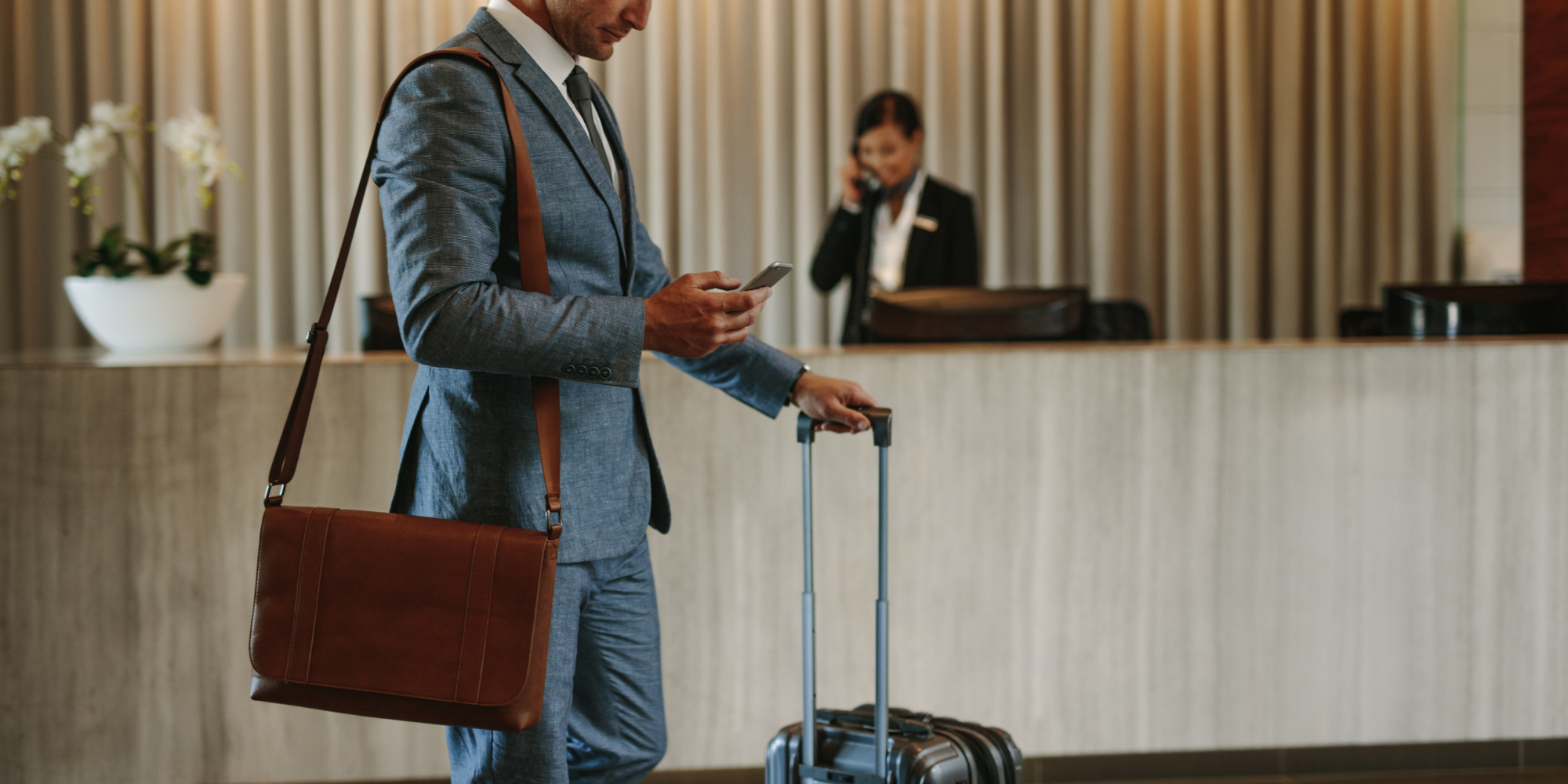 Business traveller with luggage in a hotel lobby